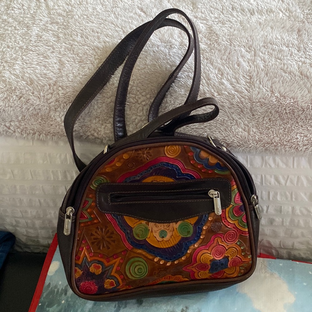 Crossbody/backpack tooling very nice feels like leather